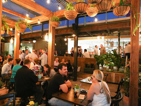 photograph of busy beer garden with happy guests